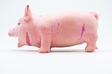 Side view of plastic pig toy on white
