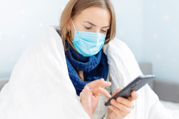 Sick woman in a medical mask calling the doctor for help and advice