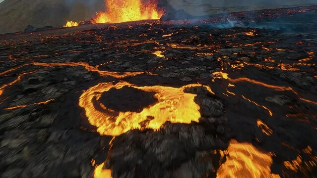 Flying low through an exploding Volcano magma cone - dramatic FPV drone shot