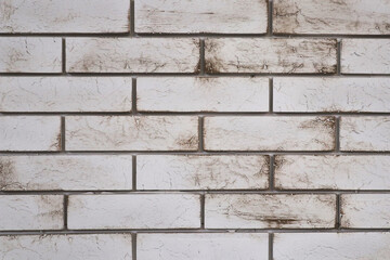 a white brick wall with dirty streaks. brick background