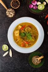 yellow curry fish or gulai ikan with tilapia fish seasoned with fresh herbs and spices
