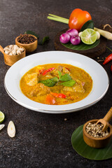 yellow curry fish or gulai ikan with tilapia fish seasoned with fresh herbs and spices