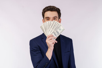 Portrait of a cheerful man holding dollar bills over white background