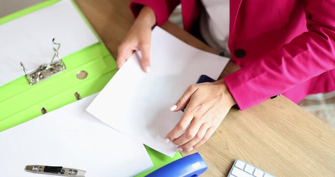 Closeup of hole puncher using documents in office