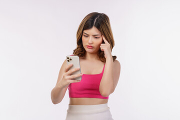 Portrait of confused young woman using mobile phone isolated over white background