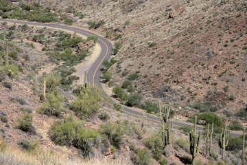 Looking down at a two-lane road making a S Turn in Tonto National Forest