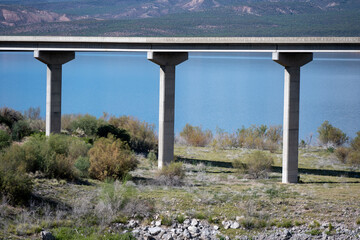 Three pillars supporting a thin steel reenforced concrete bridge