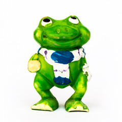 Statuette of a green frog close-up on a white background.