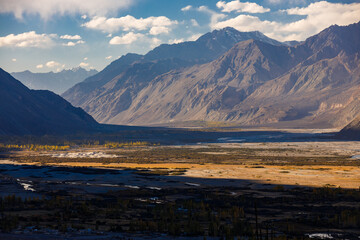 High mountain landscape in evening of autumn season with cloudy blue sky and valley in shadow of mountain at Nubra Valley, Leh, Ladakh, India.