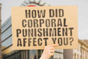 The question " How did corporal punishment affect you? " is on a banner in men's hands with blurred background. Hit. Measure. Method. Parent. Scared. Adult. Teaching. Violent. Stop. Social. Bad. Teen