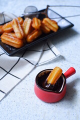 a plate  of churros in white background 
