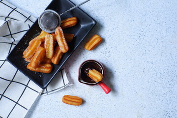 a plate  of churros in white background 