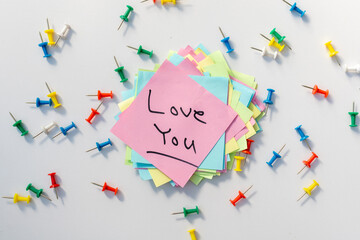 Love you postcard handwritten on a sticky note