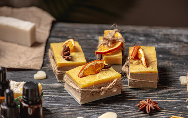 Beautiful natural soap decorated with a slice of orange and star anise. Concept of handmade organic gifts, a useful hobby, a festive atmosphere
