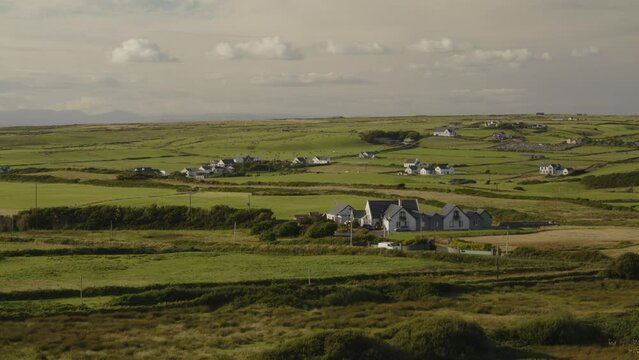 Cars driving through distant rural landscape / Doolin, Clare, Ireland