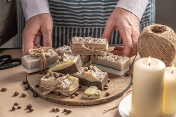 Beautiful natural coffee soap wrapped in kraft paper and tied with a ribbon. Concept of an interesting hobby and handmade gifts