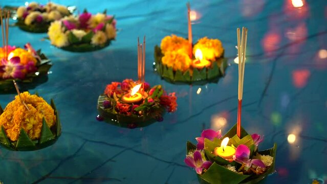 Loi Krathong festival. Krathong made from flowers lighting candle and floating on the river 
