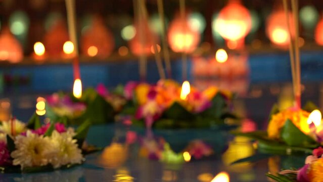 Loi Krathong festival. Krathong made from flowers lighting candle and floating on the river 