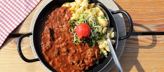 Goulash with spaetzle in a pan