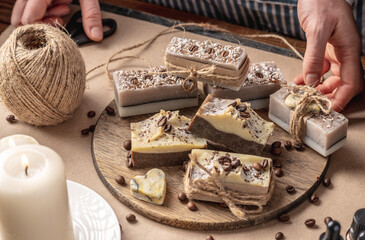 Beautiful natural coffee soap wrapped in kraft paper and tied with a ribbon. Concept of an interesting hobby and handmade gifts