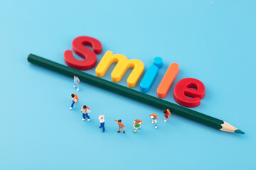 A smiley face composed of miniature creative Smile and dolls