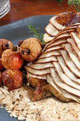 Christmas turkey, sliced with roasted fruits and almond crumbs