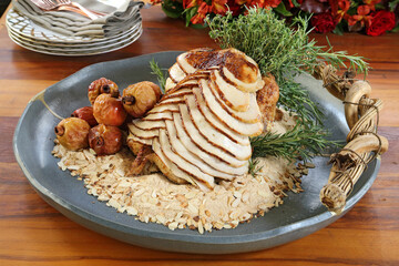 Christmas turkey, sliced with roasted fruits and almond crumbs