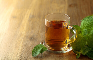 Mint tea on a wooden table.