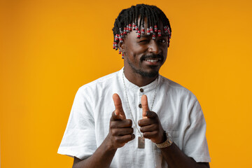 Fototapeta na wymiar Young african man pointing to camera with fingers isolated on yellow background