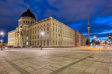 The beautiful reconstructed City Palace and the famous TV Tower in Berlin at dawn