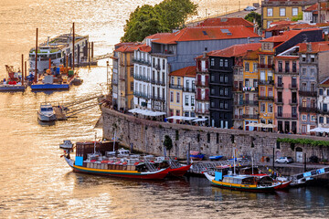 Fototapeta na wymiar Traditional Portuguese houses in Ribeira, rabelo boats on Douro, Porto, Portugal