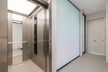 Corridor with passenger lift. Interior of modern residential building.