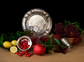 still life with a silver antique dish on a black background