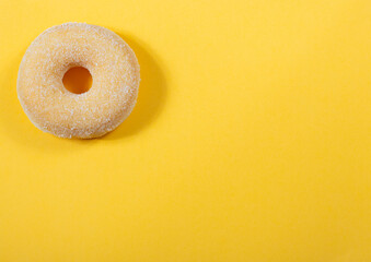 Top view of donut on yellow background