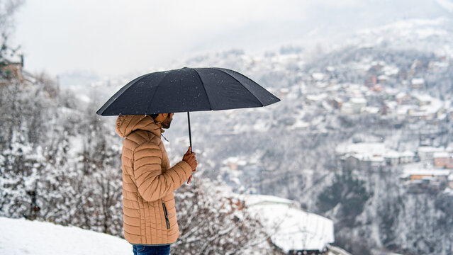Standing with Umbrella in the mountain.