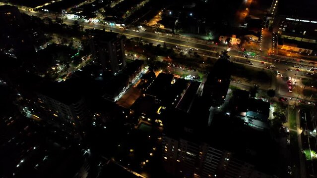 Aerial view of a residential neighborhood along a main avenue at night.