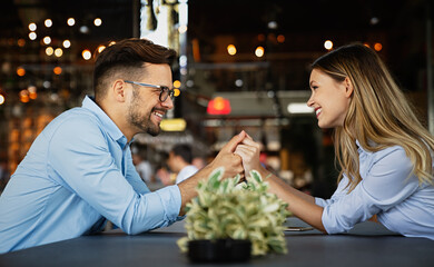 Romantic loving couple drinking coffee, having a date in the cafe.