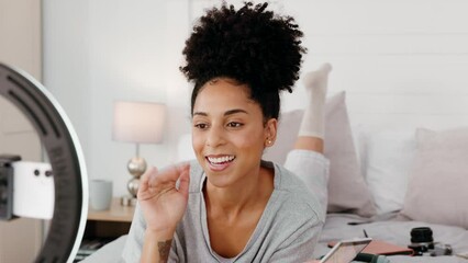Live streaming, influencer and black woman doing makeup tutorial in bedroom with phone. Social media, content creator and woman recording vlog for beauty, fashion and cosmetics products review on bed