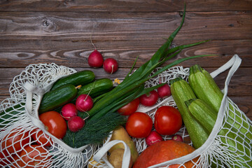 Healthy food vegetables in Eco-friendly packaging reusable bag on wooden table background.