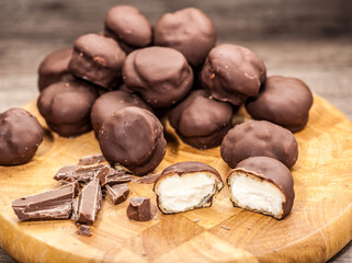 Close-up of Chocolate Cream Puffs. on wooden board