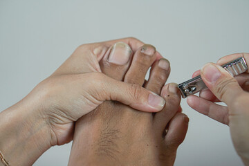 Closeup shot of a foot in a nail salon receiving a manicure by a beautician