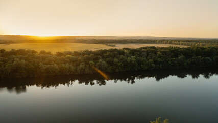 Fototapeta na wymiar Aerial view of forest horizon and river in summer at sunset.