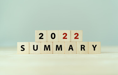2022 year summary text on wooden cube blocks on smart grey background. Past performance analysis...