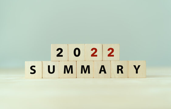 2022 year summary text on wooden cube blocks on smart grey background. Past performance analysis for learning and  improvement. Preparation for annual plan for the next year. End of year concept.