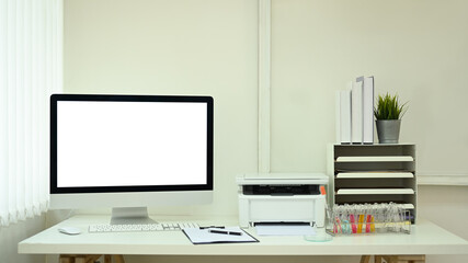 Front view of computer pc with blank monitor, reports and test tubes on white table in laboratory