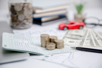 Concept of car insurance business, saving buy - sale with tax and loan for new car. Car toy vehicle with stack coin money on background. Planning to manage transportation finance costs. loan for car