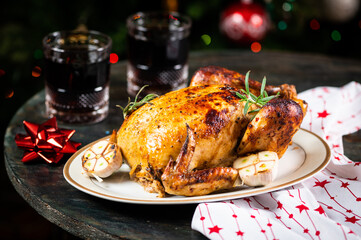 Roasted Turkey. Christmas table served with chicken, decorated with christmas decor and candles. Roasted chicken, table setting. Christmas dinner. New Year dinner.