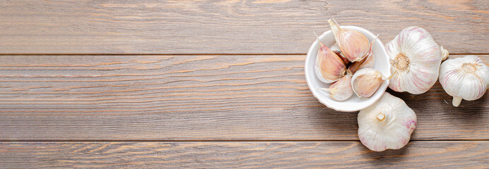 Garlic bulbs on a wooden background. Copy space.