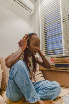 A black woman listening to music