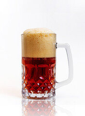 glass mug full of red beer with foam cap on top, isolated on white background